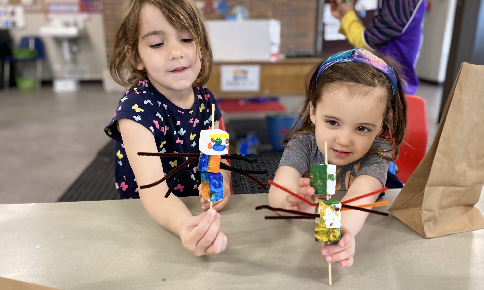 toddlers show off their crafts