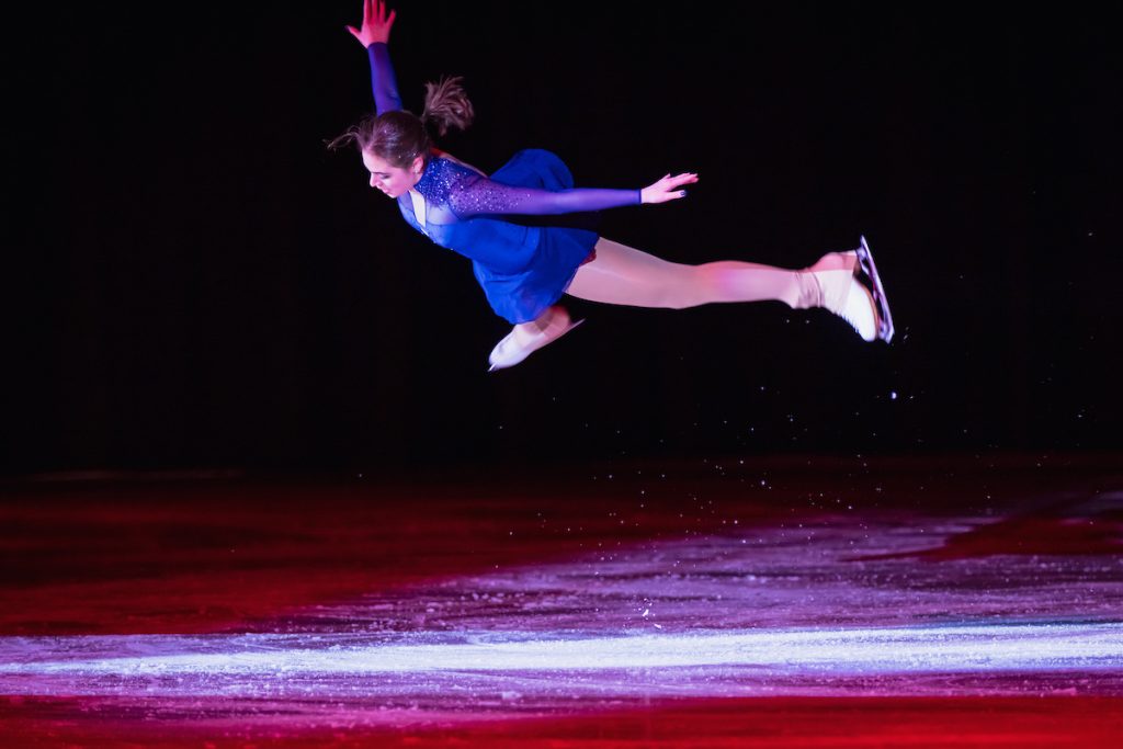 ice show performer does a jump
