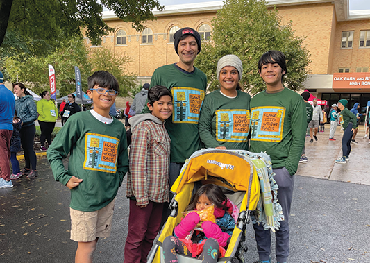 a family poses together in frank lloyd wright tshirts