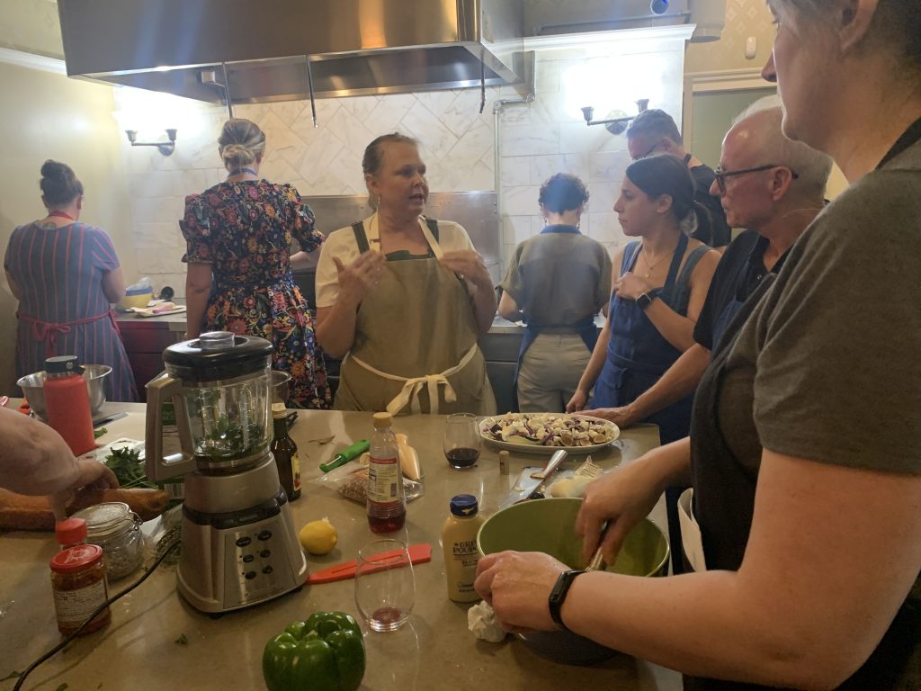 participants listen to chef tara explain ingredients and steps
