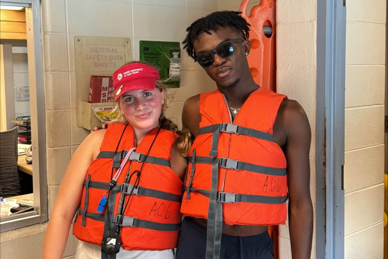 Lifeguards pose in their flotation vests