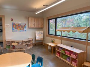 austin gardens play area with tables and blocks and an easel