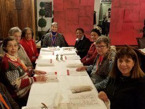 a group of women sit at a restaurant table