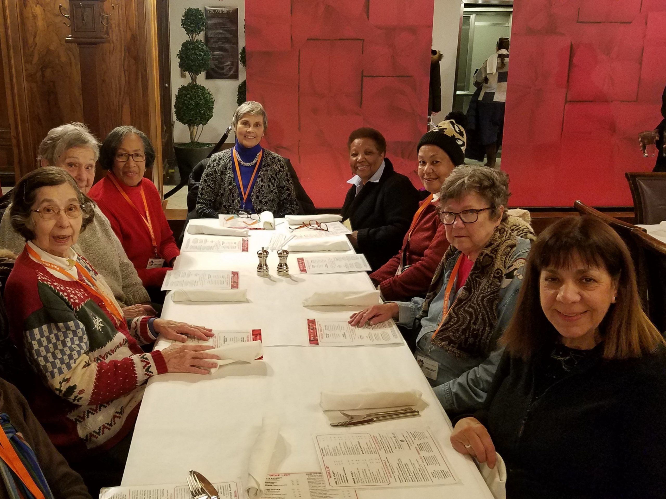 a group of women sit at a restaurant table