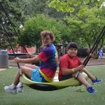two youth swing at rehm park
