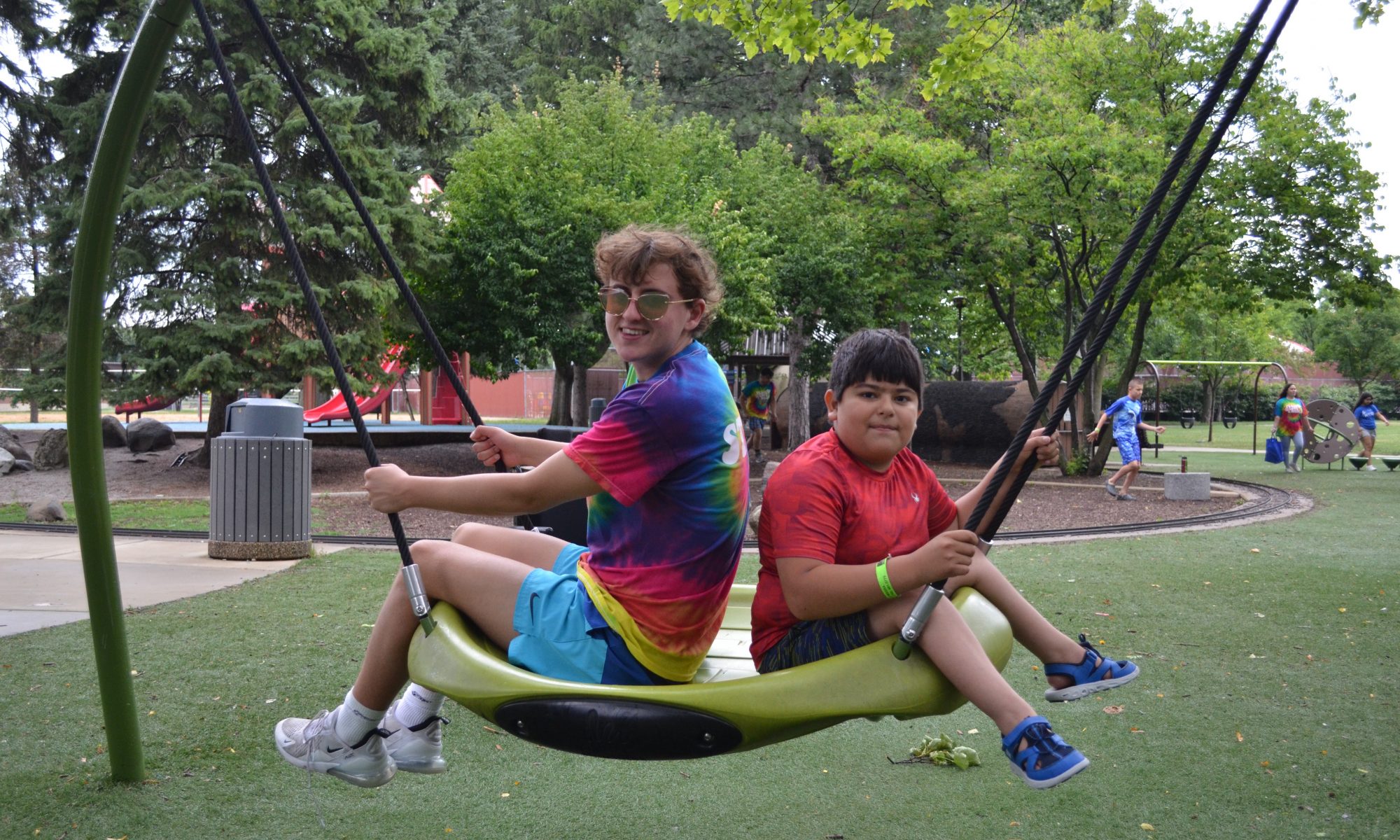 two youth swing at rehm park