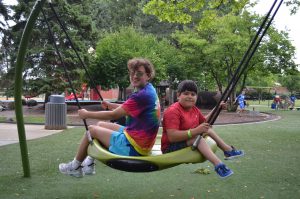 two youth swing at rehm park