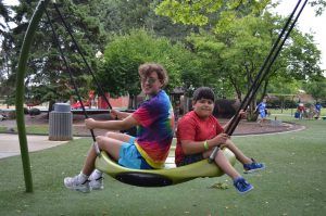 two youth swing at rehm park