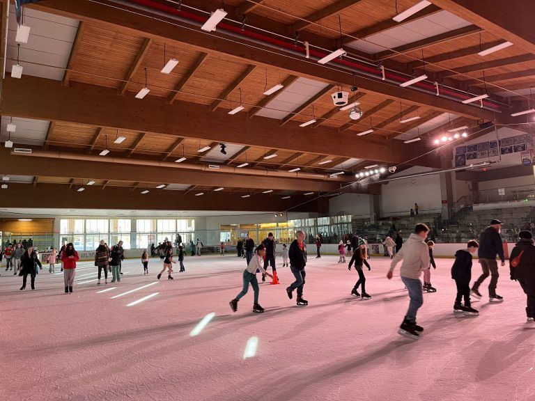skaters at the rink under pink lights