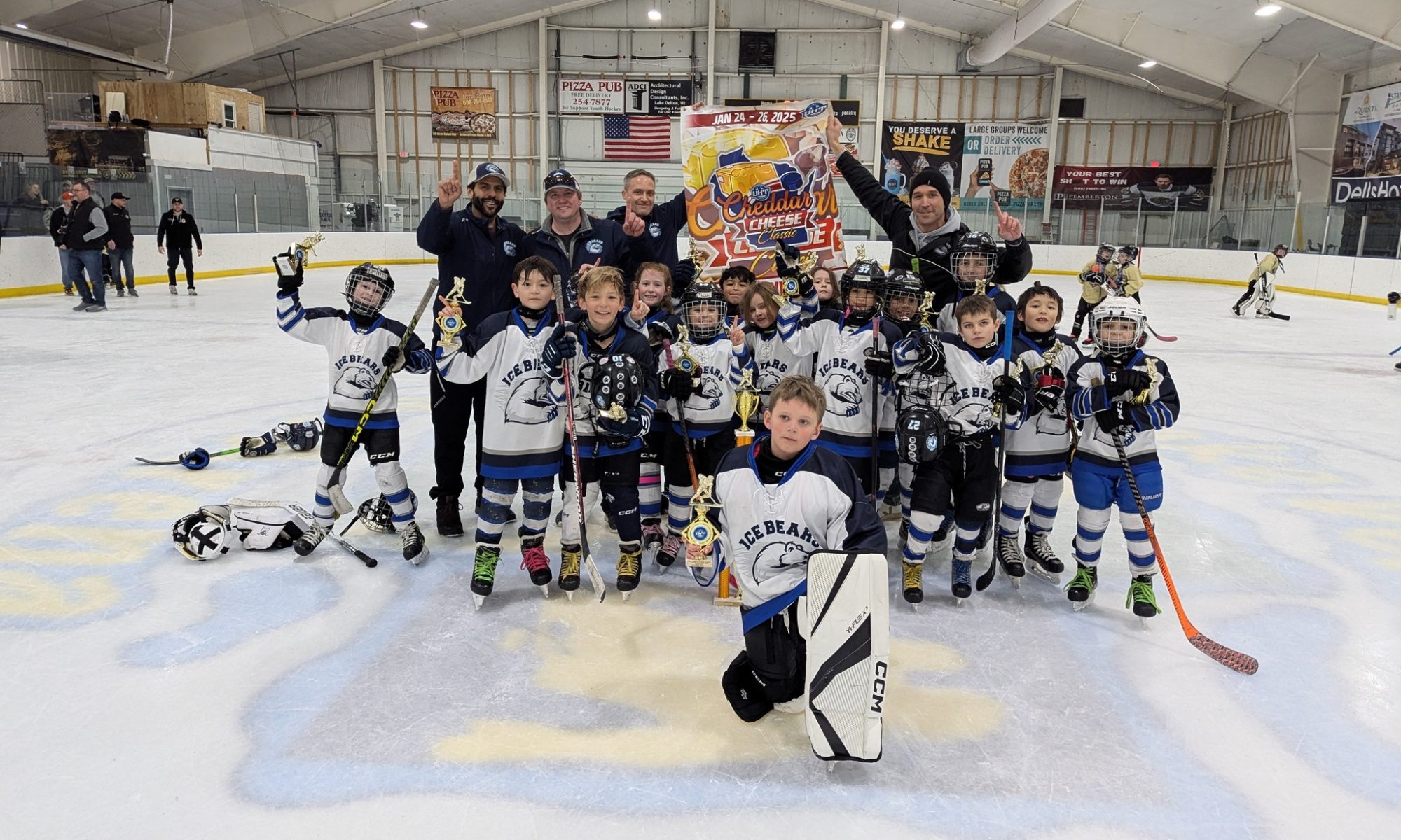 mite navy team poses with first place banner