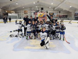 mite navy team poses with first place banner