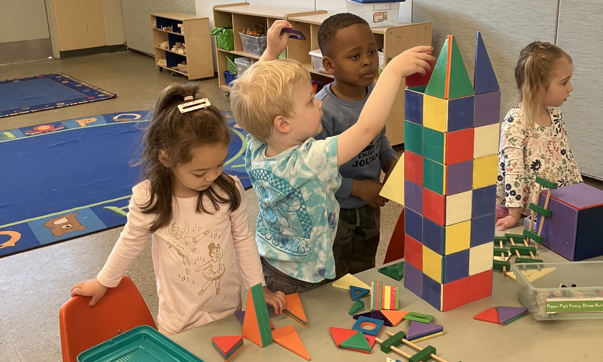 preschoolers build a tower together