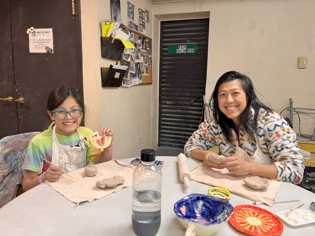 mom and daughter paint ceramics