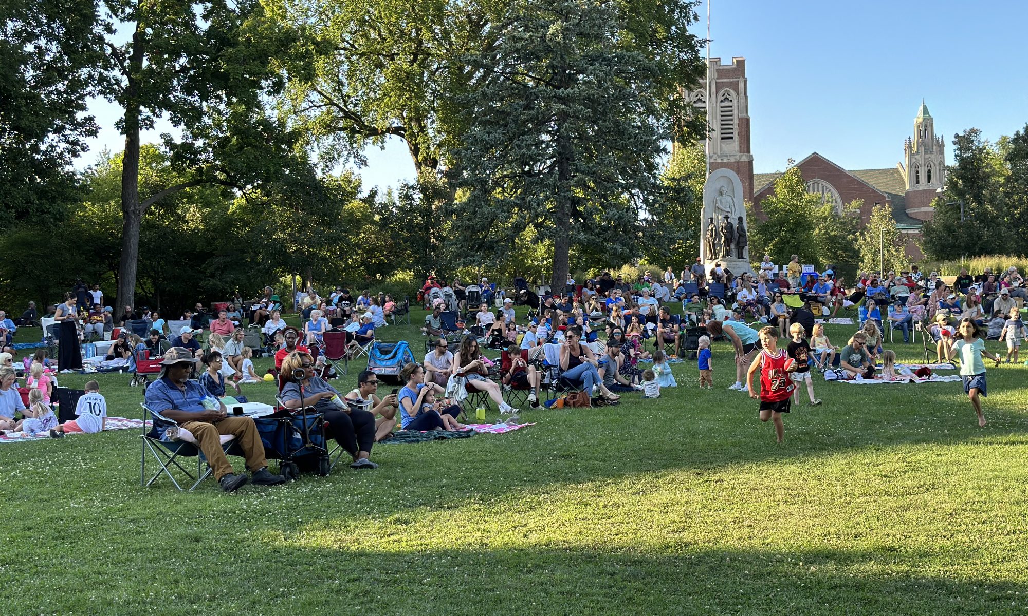 concert goers sit at scoville park