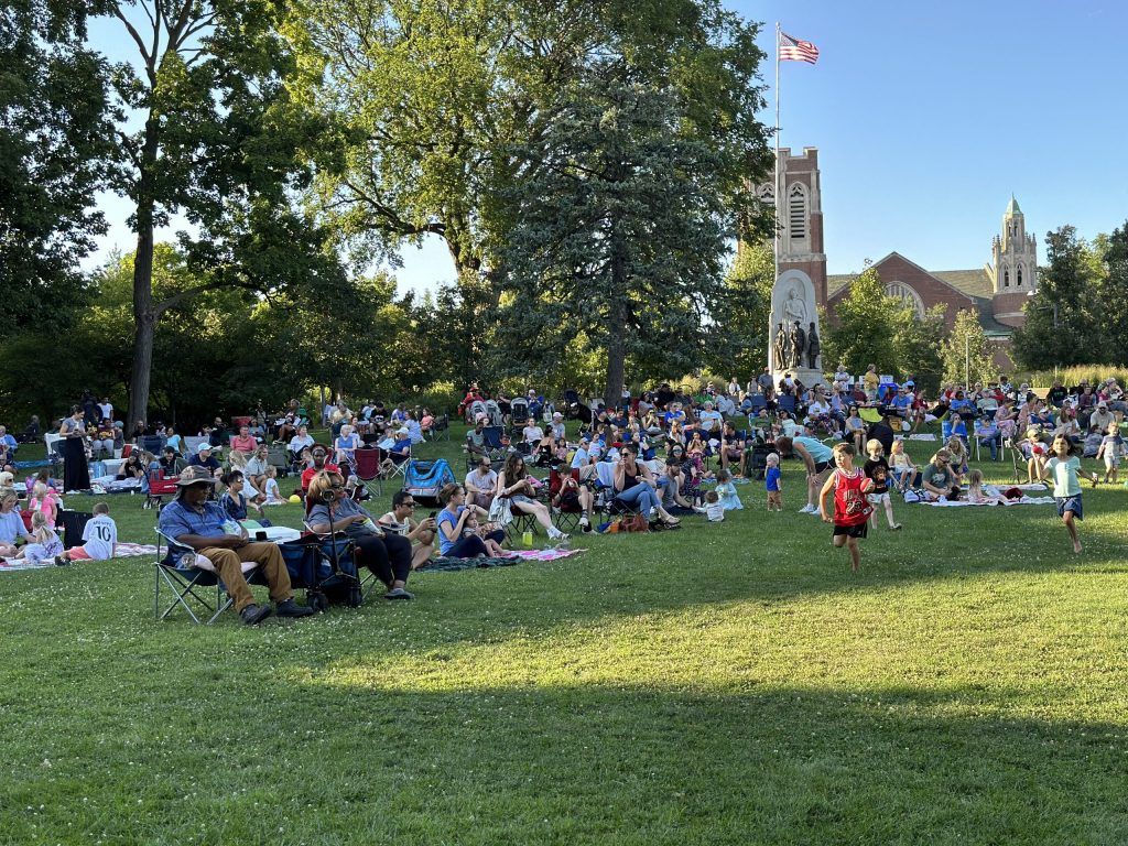 concert goers sit at scoville park