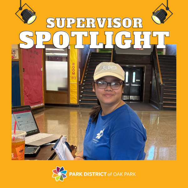 Lanh wears a visor with 'super' across it while sitting at the camp check-in desk