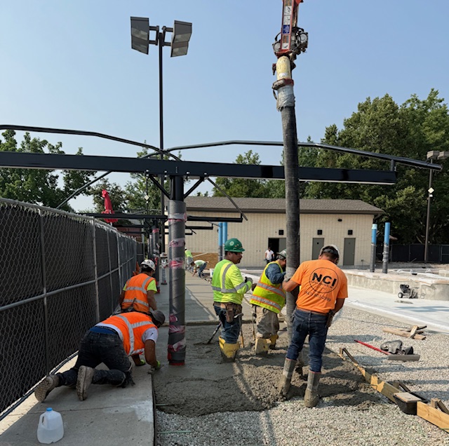 construction workers smooth the new concrete