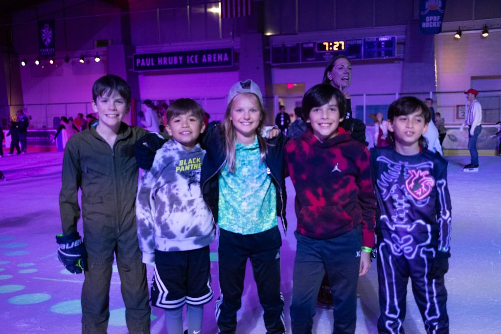 a group of tweens smile at the rink