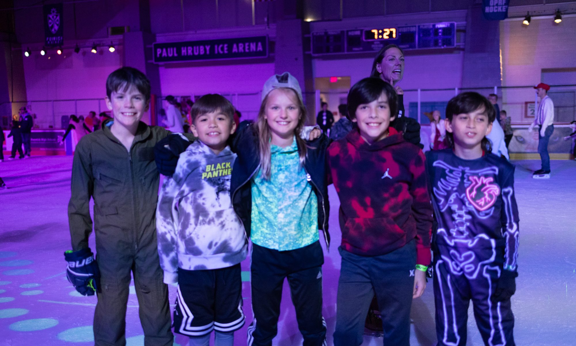 a group of tweens smile at the rink