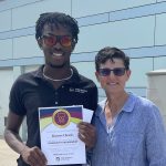 marcus cheeks and jan arnold pose with the everyday values champion certificate