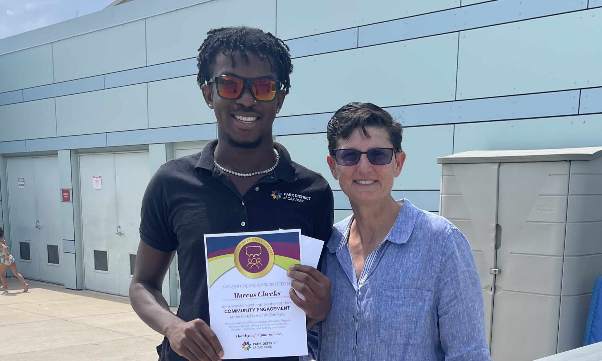 marcus cheeks and jan arnold pose with the everyday values champion certificate