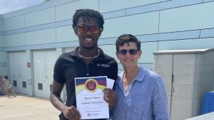 marcus cheeks and jan arnold pose with the everyday values champion certificate