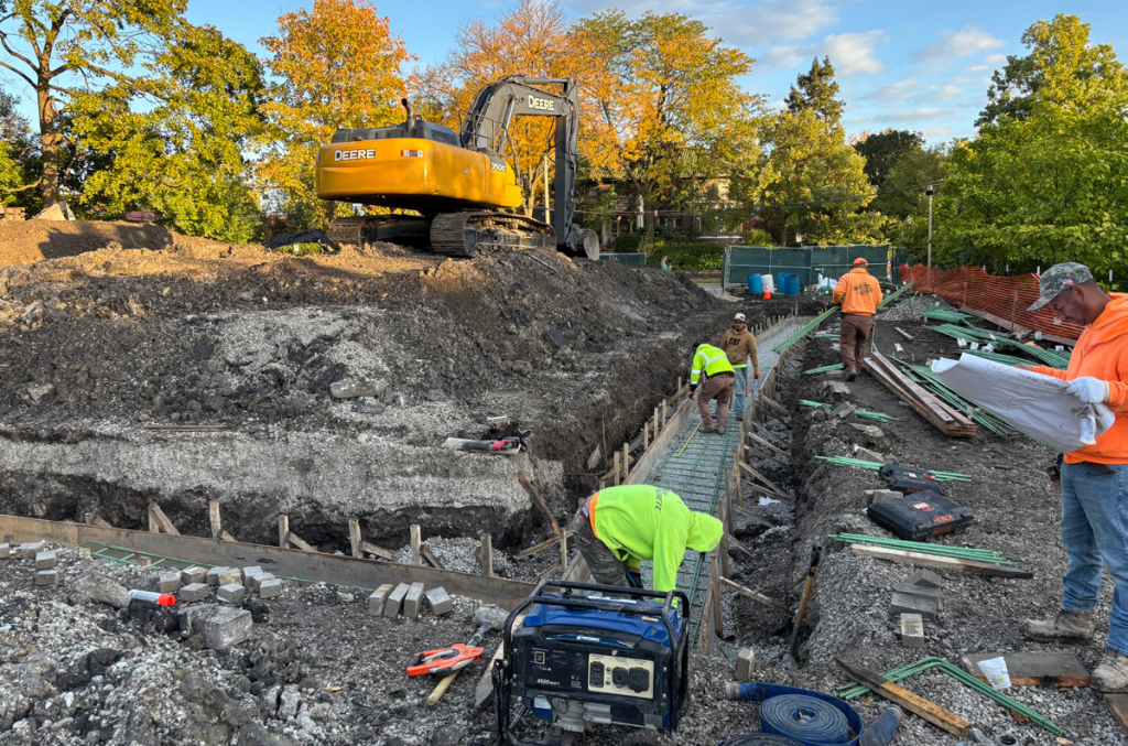 field center construction site with footings dug out and rebar installed