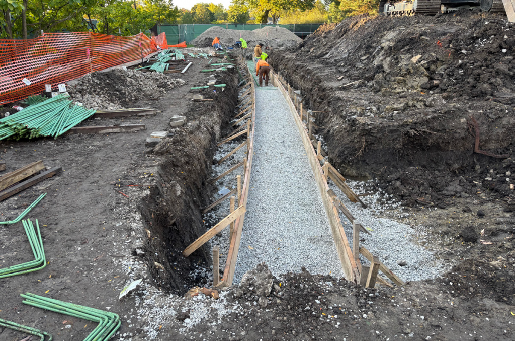 field center construction site with footings dug out and rebar installed