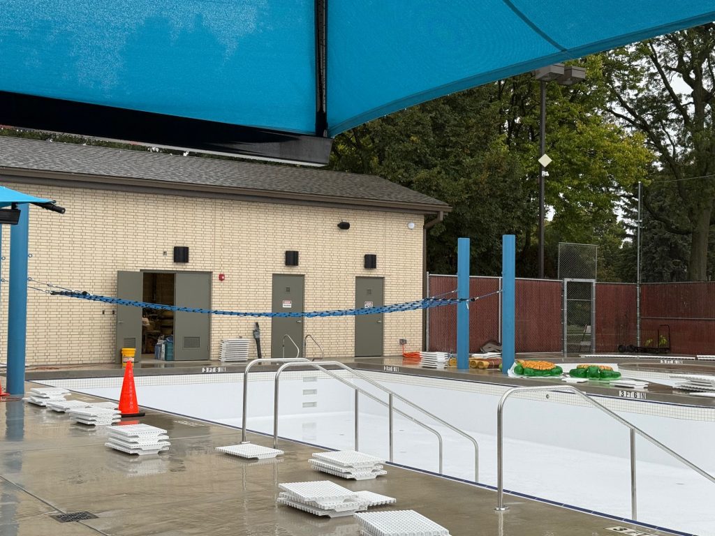 empty pool basin with lily pad crossing rope hanging over it