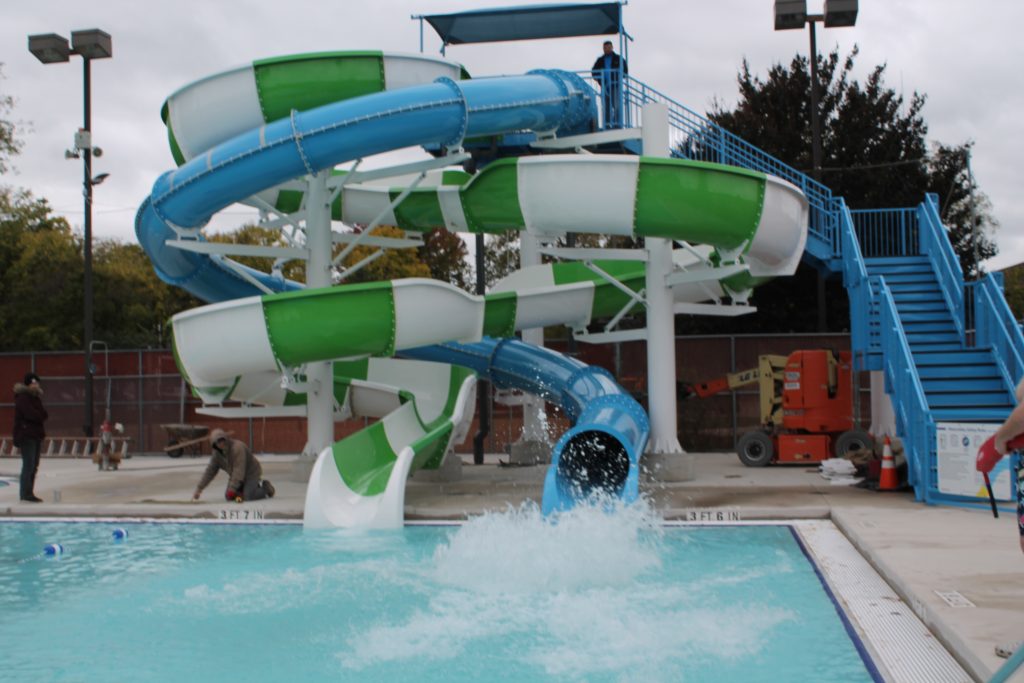 someone makes a big splash at the end of the blue waterslide