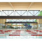 lap pool with clear divider in background showing additional pools and waterslides captioned view from lap pool