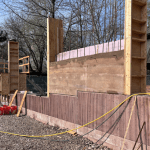 one rammed earth wall between two wood frames