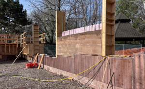 one rammed earth wall between two wood frames