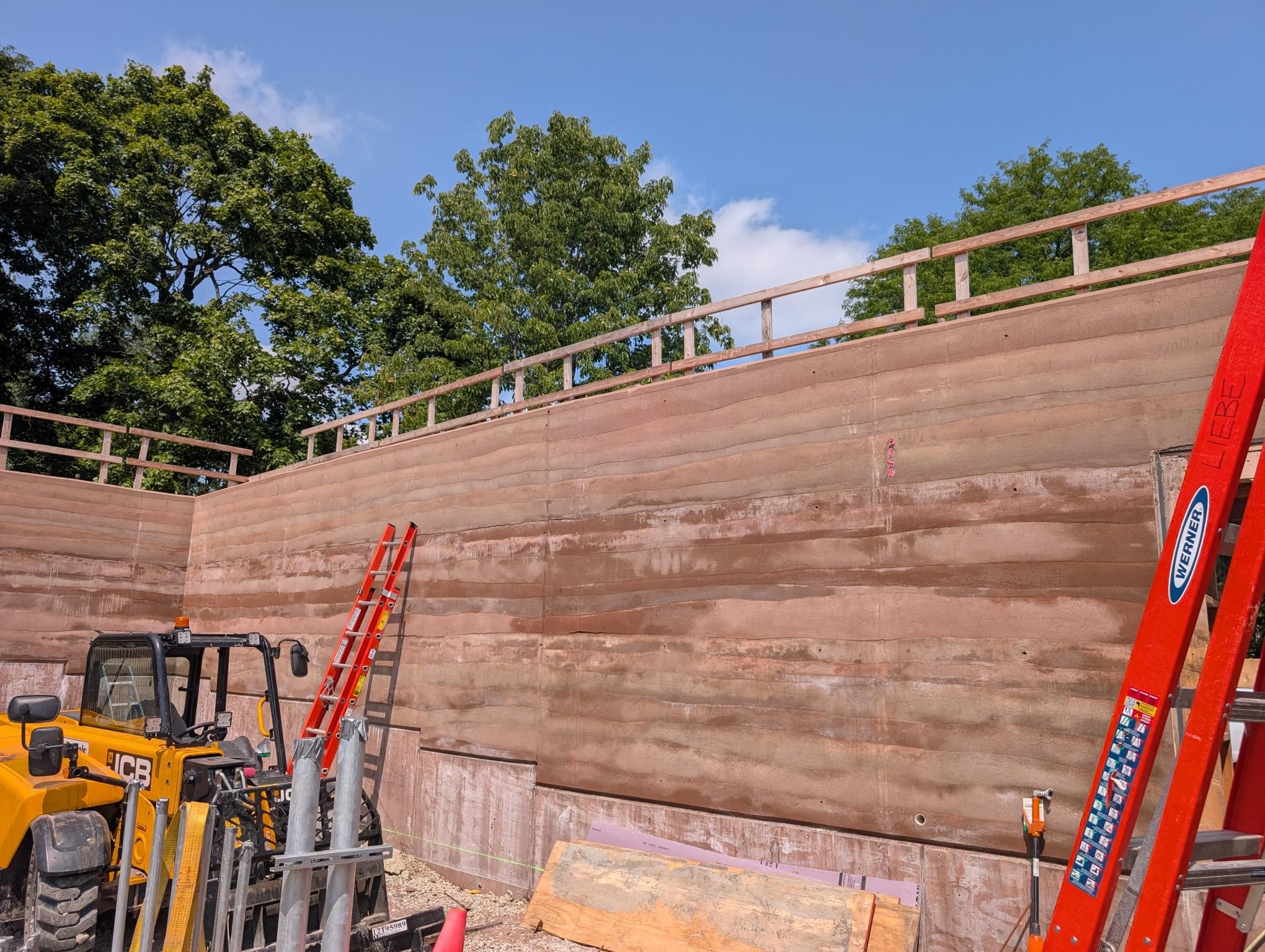 reddish layered walls against a blue sky